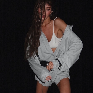 Detail of grey button-down long sleeve romper set with soft knitted fabric texture