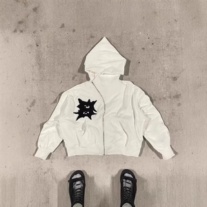 White heavy cotton hoodie with black star patch and asymmetric zipper design