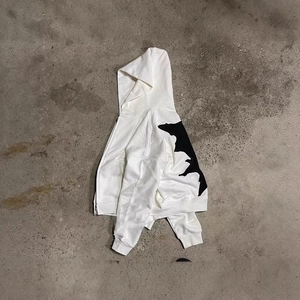 White street style hoodie with black abstract print and irregular zipper on concrete