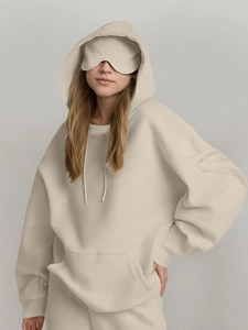 Detail view of oatmeal hoodie sleeve with functional zipper pocket and thick knit fabric texture