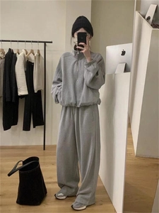 Detail view of a grey casual two-piece tracksuit with stand collar and jogger pants