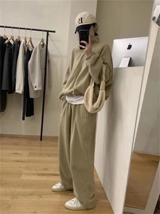 Detail of khaki oversized tracksuit featuring half-zip stand collar and wide-leg sweatpants