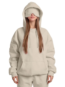 Detail of oversized sand beige hoodie showing the integrated eye mask feature on the hood