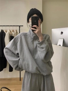 Detail showing the gray half-zip stand collar hoodie and loose matching sweatpants set