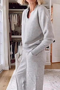Flat lay of light grey V-neck long sleeve top and wide leg pants knit lounge set