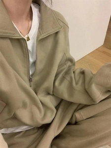 Detail of khaki zip-up stand collar sweatshirt set and casual cotton sports trousers