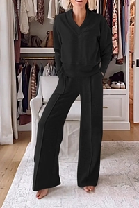 Detail of black V-neck long sleeve top and loose wide leg pants two-piece lounge set