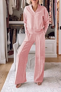 Detail of pink lounge set featuring V-neck long sleeve top and wide leg trousers