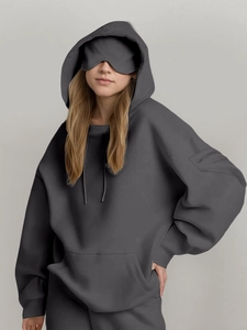 Detail of dark grey oversized hoodie with built-in sleep mask and zip pocket