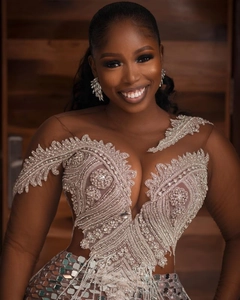 Close-up of luxury evening dress with intricate silver sequins and beadwork on mesh