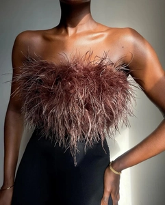 Detailed close-up of fluffy brown feather tube top with soft texture and side lighting