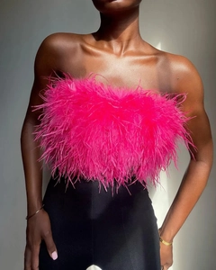 Detailed close-up of vibrant rose pink ostrich feathers on a fluffy tube top blouse