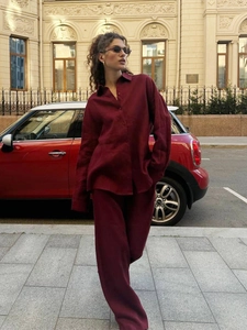 Chic burgundy linen two-piece set featuring oversized long sleeve shirt and wide-leg trousers