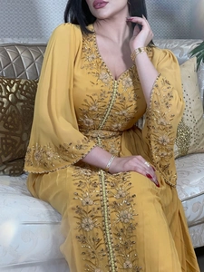 Elegant yellow caftan evening gown with intricate gold floral embroidery and hand-sewn beads