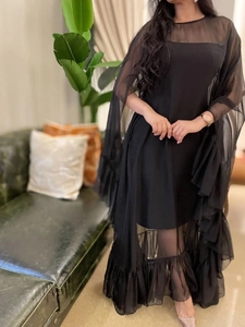 Elegant black layered tulle evening dress with ruffle hem and sheer mesh cape design
