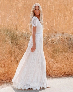 Detail of the white lace maxi dress featuring deep V-neck and short lace sleeves