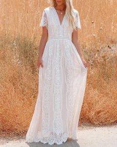 Close-up of bohemian white lace maxi dress featuring intricate floral and geometric patterns