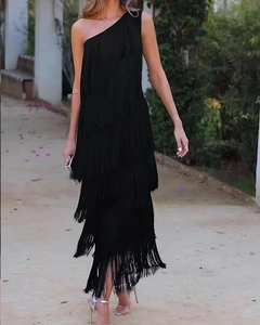 Detail of elegant black one-shoulder evening dress with layered fringe and asymmetric cut