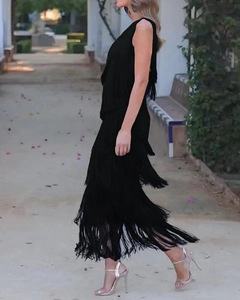 Close-up of black sleeveless dress with layered long fringes showing movement