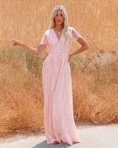 Detail of light pink lace maxi dress featuring deep V-neck and delicate floral embroidery