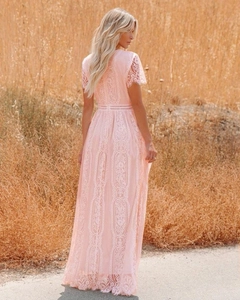 Close-up of delicate floral lace pattern and hollow waist detail on a pink tulle gown