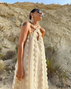 Detail of light apricot halter neck dress featuring 3D floral applique and texture