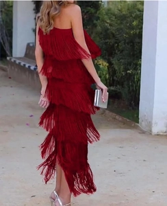 Detailed back view of red tiered fringe evening gown with elegant tassel layers