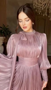 Detail of lavender pleated evening dress with lantern sleeves and beaded bow neckline