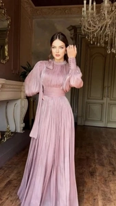 Detailed view of dusty rose pleated maxi dress with high neck and long lantern sleeves