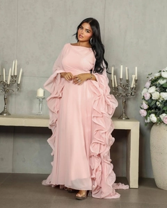 Detail of elegant pale pink evening gown featuring layered ruffle sleeves and chiffon fabric