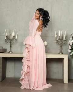 Detail of light pink tulle gown with elegant ruffle layers and back cross strap design