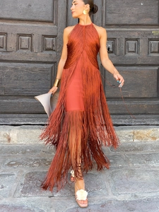 Close-up of rust red fringe detailing and halter neck design on a party dress