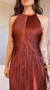 Detail of the rust red fringe maxi dress showing intensive tassels and halter neckline texture