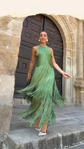 Detail of emerald green fringe halter dress featuring tiered tassels and backless cut