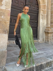Detail of elegant grass green halter neck dress featuring full-length flowing tassels