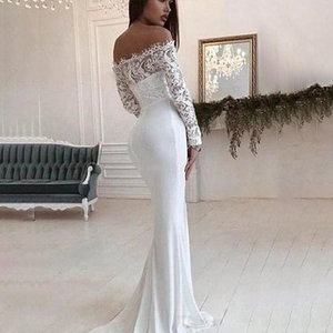 Side view of white off-shoulder lace wedding gown with an elegant mermaid silhouette tail