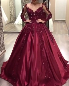 Detailed view of the V-neck lace bodice and sequins on the burgundy evening gown
