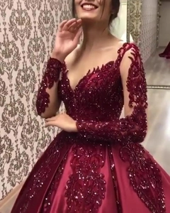 Elegant wine red lace evening gown with deep V-neck, sequins, and a satin ball gown skirt