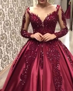 Elegant burgundy long-sleeved ball gown with lace appliques and V-neckline satin finish