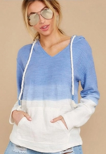 Detail of blue and white gradient knit hoodie featuring V-neck and kangaroo pocket