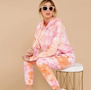Detail of pink tie-dye tracksuit set featuring long sleeve hoodie and matching joggers