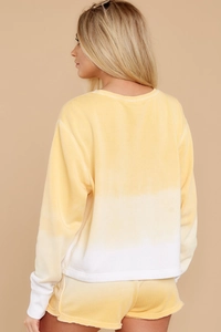 Detail shot of women's long sleeve sweatshirt and shorts set with yellow gradient effect