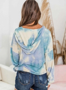 Back view of a long-sleeved blue and white tie-dye hoodie with a relaxed loose fit design