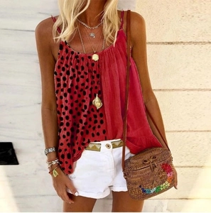 Detail of red and black polka dot bohemian camisole top with floral woven straw bag