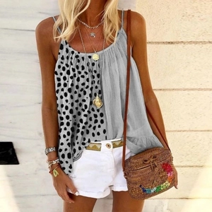 Detail of leopard print patchwork camisole with ruffle hem and bohemian accessories