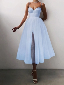 Detail of light blue mesh dress featuring high-waist cut, tiered tulle and side slit