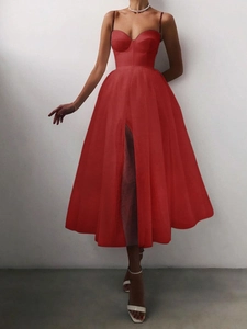 Detail of red sweetheart neckline dress with layered tulle skirt and side leg slit