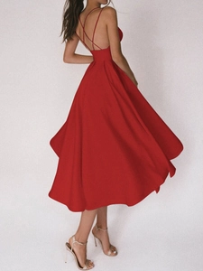 Détail de robe rouge dos nu avec fines bretelles croisées et jupe évasée volumineuse