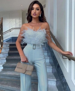 Detail of light blue feather tube top and high waist trousers with matching belt