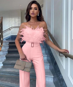 Detail of light pink feather tube top and high-waist trousers with matching belt